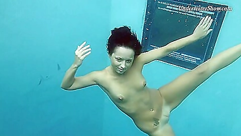 Slutty brunette with big tits naked on the pool mats