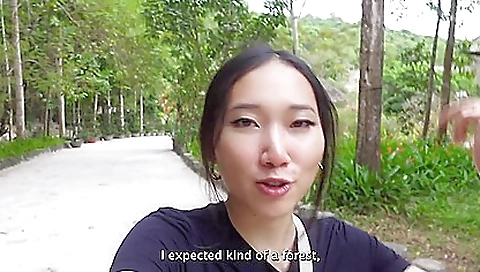 Asian brunette rides a bike and rides a bike with a guy