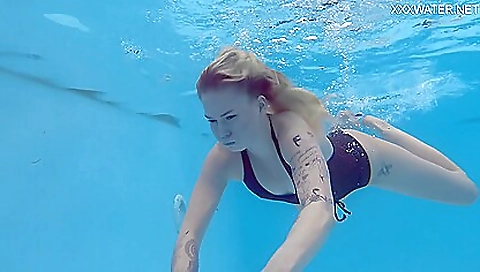 Blonde with tattoo on ass enjoys her body in the beach