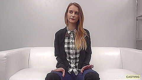 A blonde teen with a tattooed pussy is in front of a casting agent